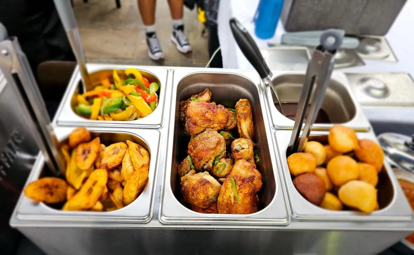 Grilled meats and sides plated for an event